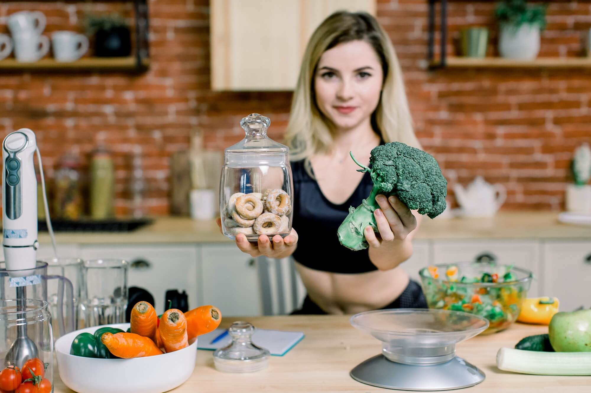 young-woman-in-black-sport-clothes-choosing-between-broccoli-or-junk-food-bagels-healthy-clean-1.jpg